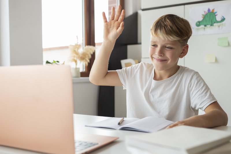 A child taking a live online Kidgency lesson at home